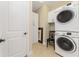 Laundry room with washer, dryer, and cabinets at 13077 Rinella St, Venice, FL 34293