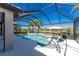Relaxing pool area with screened enclosure, offering water views at 13077 Rinella St, Venice, FL 34293