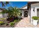 Welcoming entryway with a paved walkway and lush landscaping at 13077 Rinella St, Venice, FL 34293