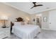 Main bedroom with a comfortable bed and ensuite bathroom access at 13077 Rinella St, Venice, FL 34293