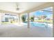 Enclosed pool and patio area with water views at 127 Marker Rd, Rotonda West, FL 33947