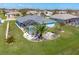 Aerial view showcasing the home's backyard oasis with a pool and lush landscaping at 153 Broadmoor Ln, Rotonda West, FL 33947