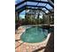 Inviting screened-in pool with a spa at 2704 Suncoast Lakes Blvd, Punta Gorda, FL 33980