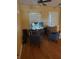 Living room with hardwood floors, two armchairs, and a large TV at 2704 Suncoast Lakes Blvd, Punta Gorda, FL 33980