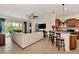 Spacious living area with a large sectional sofa, views of the pool and lanai, and access to the kitchen at 13104 Creekside Ln, Port Charlotte, FL 33953