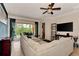 Bright living room with large sectional sofa and sliding glass doors opening to a view of the outdoors at 13104 Creekside Ln, Port Charlotte, FL 33953