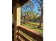 Backyard view with lush green trees and grass at 26 Quails Run Blvd # 7, Englewood, FL 34223