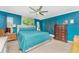 Spacious bedroom with teal bedding and ceiling fan at 22396 Elmira Blvd, Port Charlotte, FL 33952