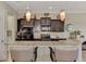 Updated kitchen featuring dark cabinetry and granite countertops at 13033 N Marsh Dr, Port Charlotte, FL 33953