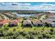 Aerial view of a single-Gathering home with a backyard and a lake nearby at 13033 N Marsh Dr, Port Charlotte, FL 33953