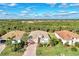 Aerial view of a house in a residential neighborhood with lush landscaping at 13033 N Marsh Dr, Port Charlotte, FL 33953