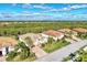 Aerial view of a house with a driveway and landscaping in a residential area at 13033 N Marsh Dr, Port Charlotte, FL 33953