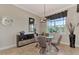 Elegant dining area features glass table, four chairs, and a view to backyard at 13033 North Marsh Dr, Port Charlotte, FL 33953