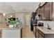 Modern kitchen features granite countertops, dark wood cabinets, and stainless steel appliances at 13033 N Marsh Dr, Port Charlotte, FL 33953