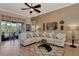 Relaxing living room featuring a sectional sofa and large windows at 13033 N Marsh Dr, Port Charlotte, FL 33953