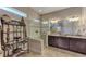 Spa-like bathroom with a walk-in shower and double vanity at 13033 N Marsh Dr, Port Charlotte, FL 33953