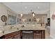 Kitchen with granite countertops, stainless steel appliances, and view into living area at 13033 N Marsh Dr, Port Charlotte, FL 33953