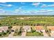 Aerial view of houses in a neighborhood with a natural preserve backdrop at 13033 N Marsh Dr, Port Charlotte, FL 33953
