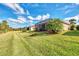Spacious backyard with grassy area and screened patio at 13033 N Marsh Dr, Port Charlotte, FL 33953