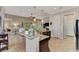 Open kitchen boasts granite counters, dark cabinetry, and breakfast bar overlooking living room at 13033 N Marsh Dr, Port Charlotte, FL 33953