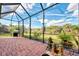 Screened patio with grill and tranquil backyard view at 13033 N Marsh Dr, Port Charlotte, FL 33953