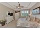 Bright bedroom features a ceiling fan, large windows, and plenty of storage at 13033 N Marsh Dr, Port Charlotte, FL 33953