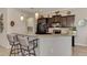 Modern kitchen with dark wood cabinets and breakfast bar at 13033 N Marsh Dr, Port Charlotte, FL 33953