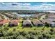 Aerial view of community with lake and numerous homes at 13033 N Marsh Dr, Port Charlotte, FL 33953