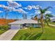 Single-Gathering home with metal roof and palm trees at 9307 San Bernandino Ave, Englewood, FL 34224