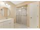 Bathroom with a walk-in shower, single vanity, and access to backyard at 9307 San Bernandino Ave, Englewood, FL 34224