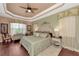 Large main bedroom with wood floors, a plush bed, and access to the patio at 13392 Golf Pointe Dr, Port Charlotte, FL 33953