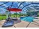 Enjoy this luxurious pool and spa with a screened enclosure and relaxing lounge chairs at 13392 Golf Pointe Dr, Port Charlotte, FL 33953