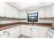 White kitchen cabinets and granite countertops at 150 Englewood Isles Pkwy # 206, Englewood, FL 34223