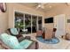 Bright patio with wicker furniture, a sliding glass door, and a flat-screen TV at 2844 Myakka Creek Ct, Port Charlotte, FL 33953