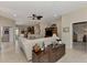 Open concept living room, featuring a large sectional sofa and views to kitchen and hallway at 2844 Myakka Creek Ct, Port Charlotte, FL 33953