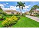 Single story home with tile roof, attached garage, and manicured landscaping at 2844 Myakka Creek Ct, Port Charlotte, FL 33953