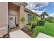 Front entry with light beige walls, decorative wreath and lush landscaping at 2844 Myakka Creek Ct, Port Charlotte, FL 33953