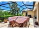 Covered hot tub with a brown cover in a beautiful screened lanai at 2844 Myakka Creek Ct, Port Charlotte, FL 33953