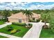 Single-story home with tile roof, two-car garage, and landscaped yard at 2844 Myakka Creek Ct, Port Charlotte, FL 33953