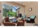 Covered patio with a glass-top table and chairs, overlooking a lush backyard at 2844 Myakka Creek Ct, Port Charlotte, FL 33953