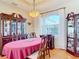 Bright dining room featuring an oval table, large window, and hardwood floors at 18138 Avonsdale Cir, Port Charlotte, FL 33948