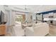 Open living room with view of pool and kitchen at 10985 Trevino St, Englewood, FL 34223
