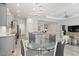 Open concept kitchen and dining area with gray cabinets and granite counters at 10985 Trevino St, Englewood, FL 34223