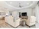 Bright living room boasts a large TV, comfortable seating, and tile floors at 10985 Trevino St, Englewood, FL 34223