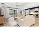 Open living space features tile floors, comfy sofas, and a view of the pool at 10985 Trevino St, Englewood, FL 34223