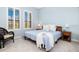 Light and airy bedroom with a light blue comforter at 10985 Trevino St, Englewood, FL 34223