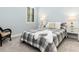 Cozy bedroom featuring a plaid comforter and a wicker chair at 10985 Trevino St, Englewood, FL 34223