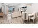 Open dining room with a large table and access to the living room at 10985 Trevino St, Englewood, FL 34223