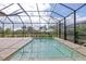 Relaxing screened pool and lanai with paver deck at 10985 Trevino St, Englewood, FL 34223