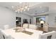 Modern dining room with a large table and view of the living room at 10985 Trevino St, Englewood, FL 34223